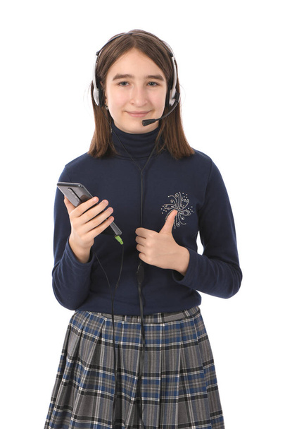 Pre-adolescent girl listening to music on black smartphone. isolated on white background. High resolution photo. Full depth of field. - Photo, Image