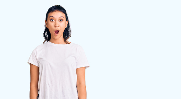 Young woman wearing casual clothes afraid and shocked with surprise expression, fear and excited face.  - Photo, Image