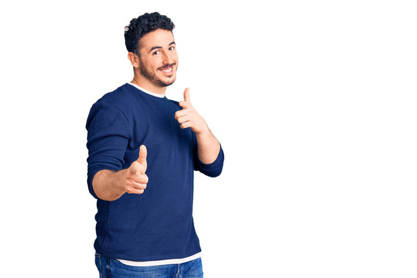 Young hispanic man wearing casual clothes pointing fingers to camera with happy and funny face. good energy and vibes.  - Fotoğraf, Görsel