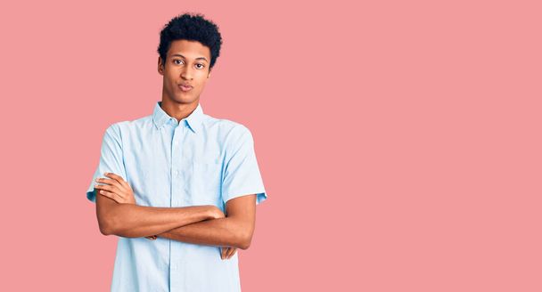 Young african american man wearing casual clothes skeptic and nervous, disapproving expression on face with crossed arms. negative person.  - Photo, Image