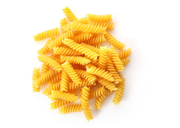 Heap of raw fusilli pasta isolated on white background. Top view. - Photo, Image