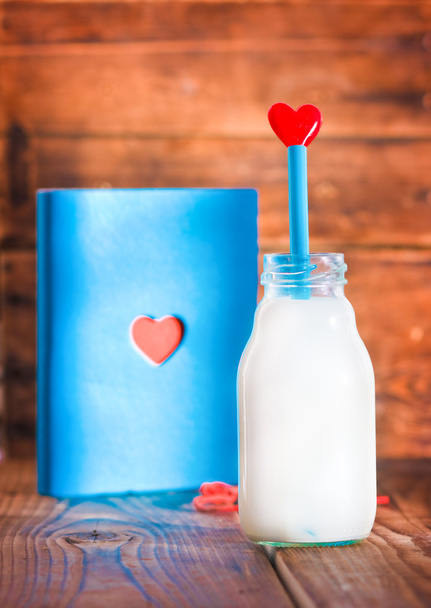 Notebook and bottle of milk with heart - Valokuva, kuva
