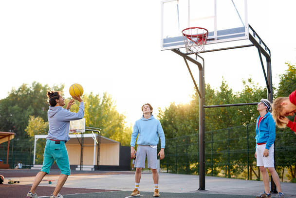 basketball players outdoors. summer vacation, holidays, games and friendship concept - Photo, image