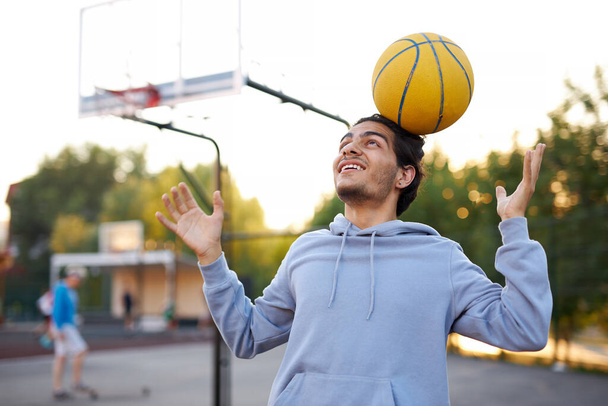 teen basketballer boy perform different tricks with the use of ball - Fotoğraf, Görsel