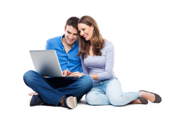 Young couple with laptop computer - Фото, изображение