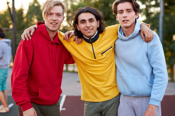 friendly modern guys 16 years old posing at camera in city streets - Φωτογραφία, εικόνα
