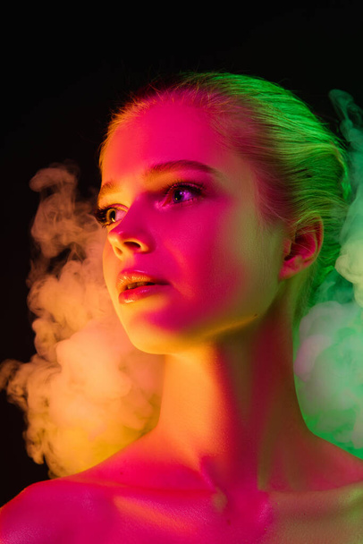 Portrait of female fashion model in neon light on dark studio background. - Φωτογραφία, εικόνα