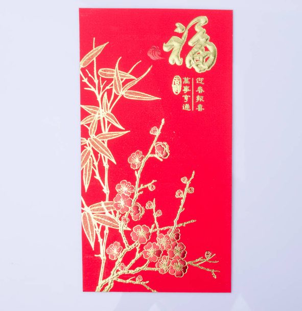 Chinese New Year - Mandarin orange, gold sycee (Foreign text means wealth) and red packet - Photo, Image