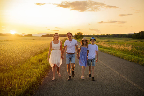 happy family at sunset. They having fun and playing in nature at sunset - Photo, image