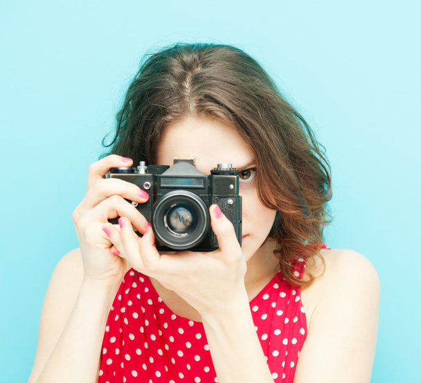 beautiful girl with vintage photo camera on a blue background in - Фото, зображення