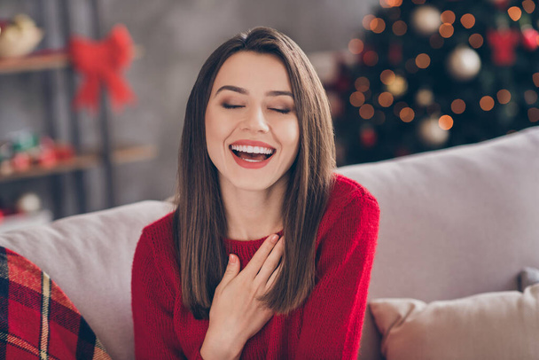 Photo of cheerful girl laughing in house living room with christmas newyear decoration tinsels - Foto, imagen