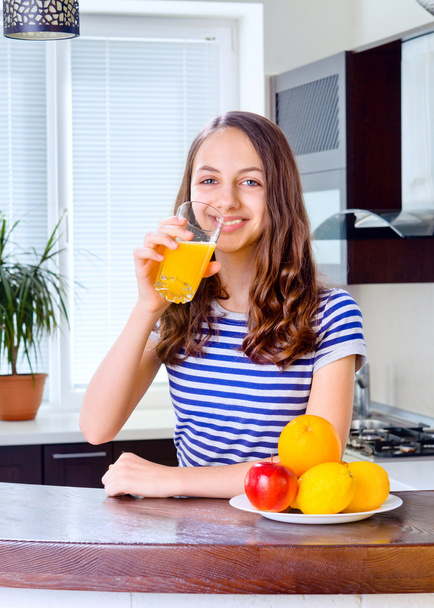 Young woman holding glass of orange juice - Фото, изображение
