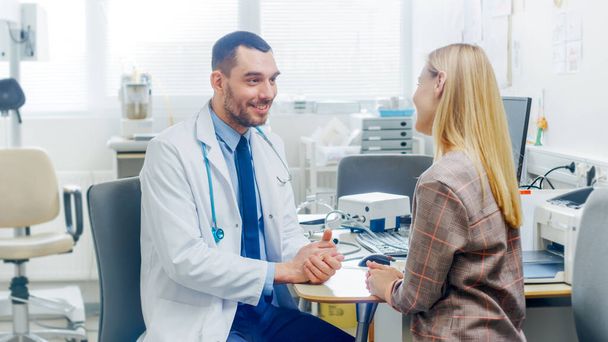 In Medical Office Friendly Doctor Talks with a Beautiful Blonde Woman. Health Care Professional Consultation in the Bright Modern Office. - Photo, Image