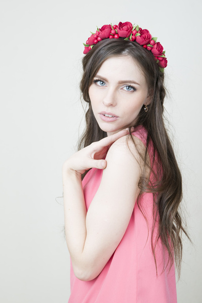 Young beautiful woman with flower wreath on head - Фото, изображение