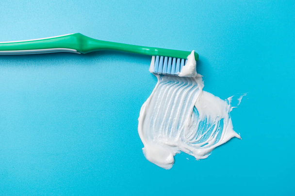 Toothbrush and toothpaste on a blue background. Dental hygiene concept. - Photo, image