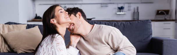 Cheerful brunette woman touching boyfriend at home, banner  - Photo, Image