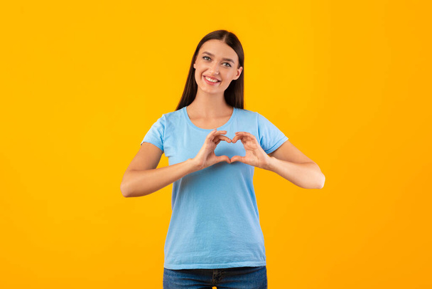 Woman making heart shape with her hands - Photo, Image