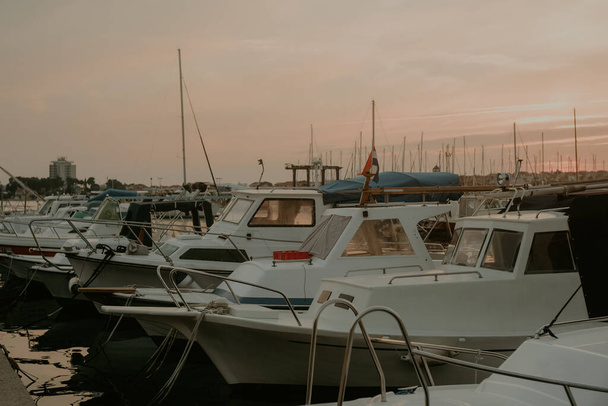 There are many yachts, boats and ships at sea. Marina at sunset. - Фото, зображення