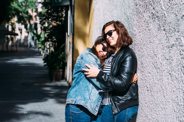 couple of women hugging in the street - Фото, зображення