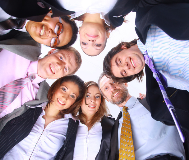 Group of business standing in huddle, smiling, low angle view - Photo, image