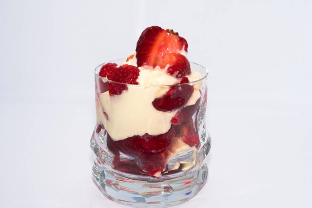 STRAWBERRY DESSERT WITH CREAM SERVED IN GLASS CUP - Photo, Image