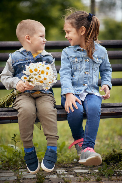 Preschool boy and girl romance in a park - Fotó, kép