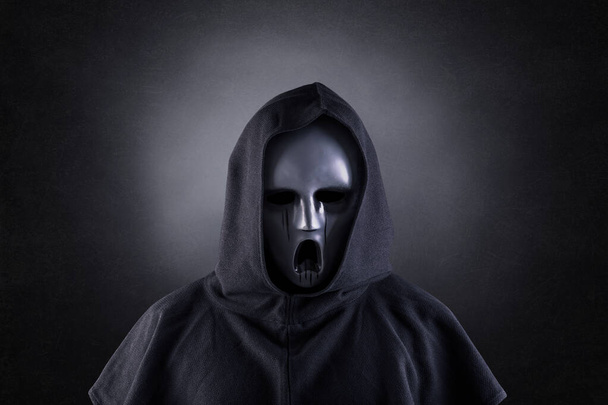 Ghostly figure in hooded cloak in the dark - Fotoğraf, Görsel