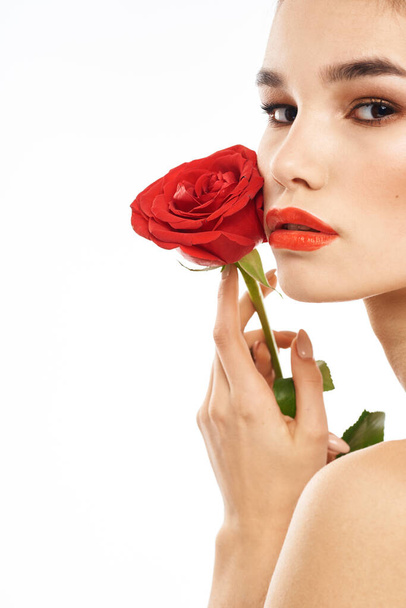 Portrait of woman with red rose naked shoulders Make-up on brunette face - Photo, Image