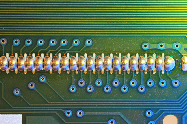 Extreme close up shot of  printed circuit board with series of soldering - Photo, Image