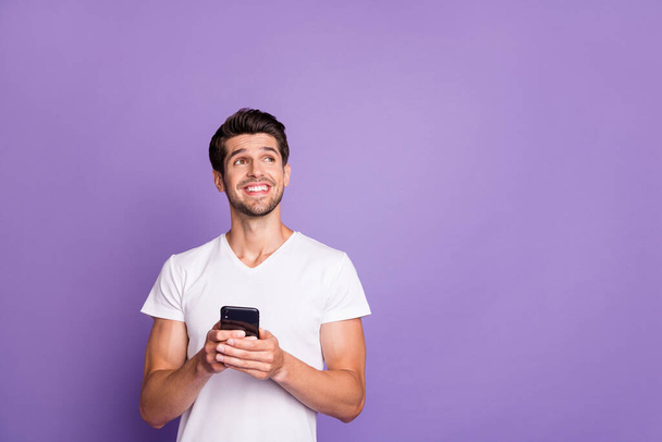 Portrait of his he nice attractive cheerful cheery glad dreamy creative guy using digital device creating smm like isolated over bright vivid shine vibrant violet lilac purple color background - Foto, imagen