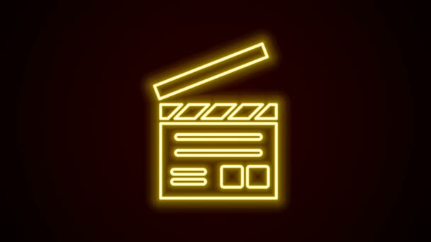 Świecąca neonowa ikona klaszczącego filmu odizolowana na czarnym tle. Deska do klapsów. Znak klaśnięcia. Produkcja kinowa lub przemysł medialny. 4K Animacja graficzna ruchu wideo - Materiał filmowy, wideo