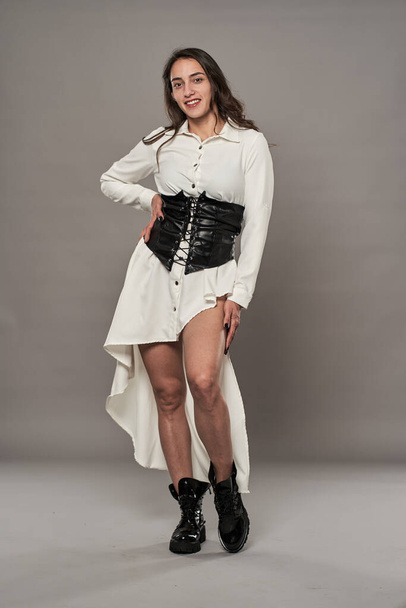 Hispanic glamour female model in white dress, boots and corset - Fotó, kép