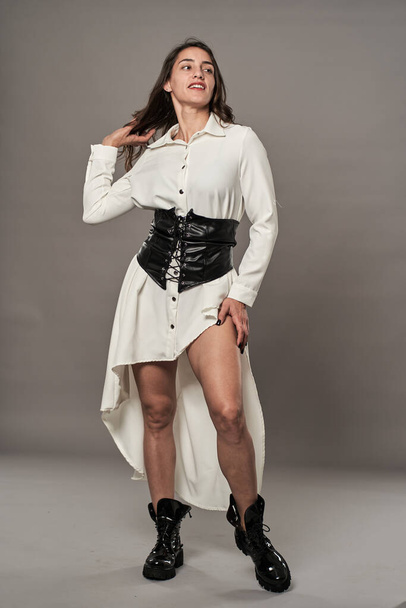 Hispanic glamour female model in white dress, boots and corset - Fotoğraf, Görsel