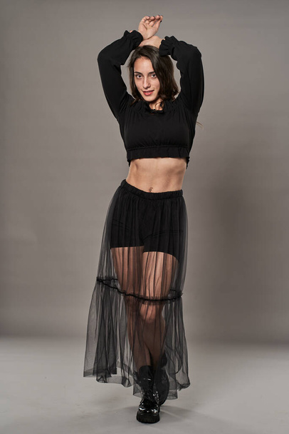 Gorgeous glamour model girl dressed in black on gray background - Fotó, kép