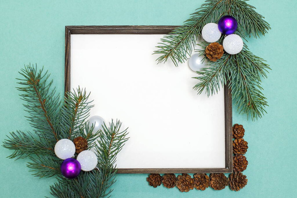 Christmas composition of fir branches, pine cones, Christmas toys and decorations. Christmas frame with space for text - Фото, изображение
