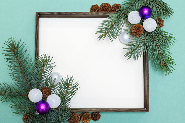 Christmas composition of fir branches, pine cones, Christmas toys and decorations. Christmas frame with space for text - Photo, image