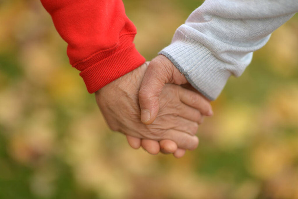 Couple holding  hands together   - Φωτογραφία, εικόνα