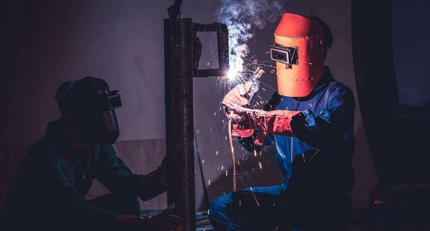 Metal welding steel works using electric arc welding machine - Foto, afbeelding