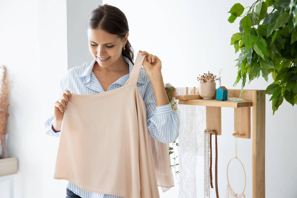 woman trying her new cloth, fashion fitting concept - Фото, зображення