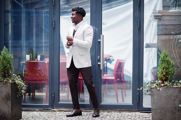 Thoughtful young handsome african american gentleman in formalwear. Black stylish model man in white jacket. - Fotó, kép