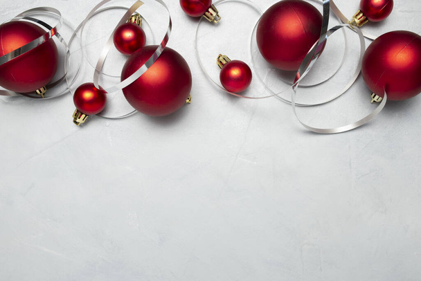 A top view of red Christmas balls on gray background - Photo, Image