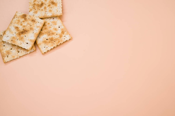 A closeup shot  of the delicious crispy crackers on the orange surface - Foto, Imagem