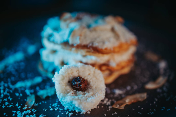 A selective focus shot of pancake with coconut flakes on a plate - Фото, зображення