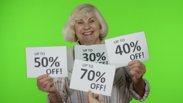 Babička ukazuje reklamní nápisy s procentuálními slevami. Koncept Černého pátku - Záběry, video