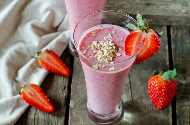 Strawberry smoothie on a wooden table - Photo, Image