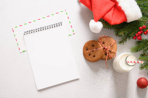Milk for Santa Clause and homemade gingerbread cookies on white background. View from above. Copy space - Foto, imagen