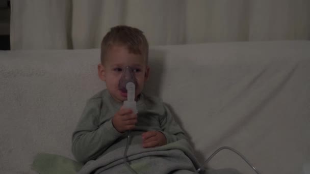 medicine, self-medication concept. Child with asthma problems make inhalation with mask on face, coughing. Sick kid respiratory breathes infection bronchitis. Treatment of pneumonia nebulizer at home - Footage, Video