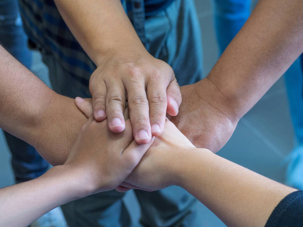 Close-up hands of friends joined together. Concept of unity and teamwork - Photo, Image