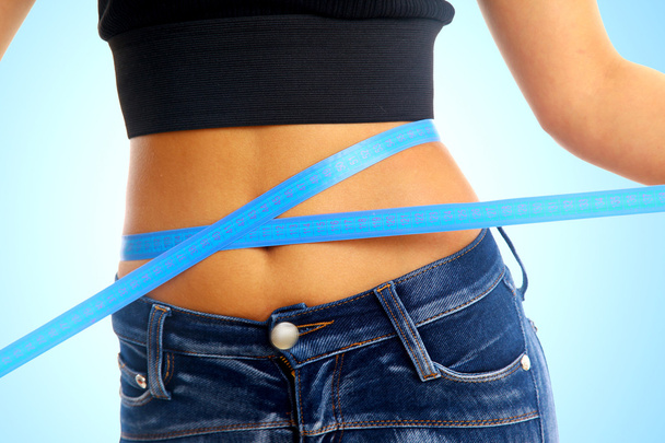 Measure tape around slim beautiful waist. - Фото, зображення