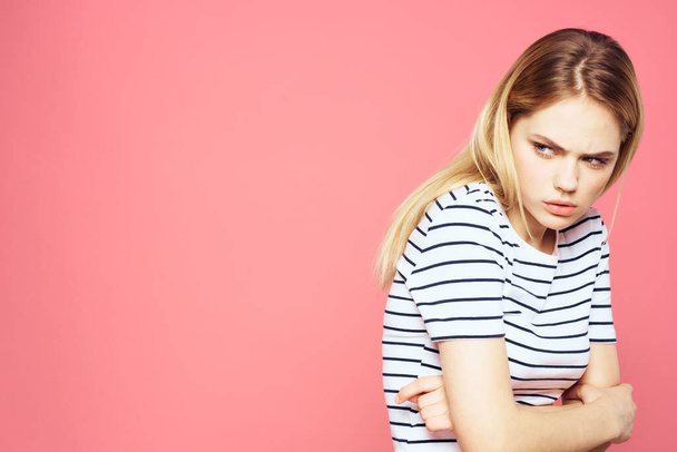 Blonde striped t-shirt emotion gesture hands displeased facial expression pink background - Photo, Image
